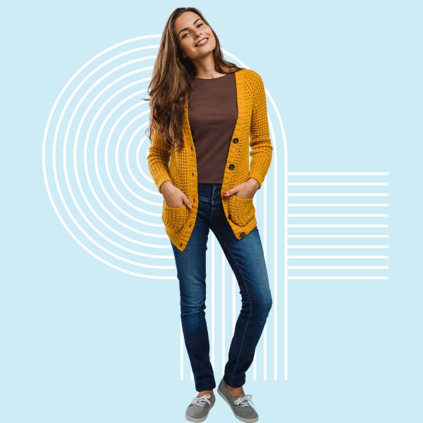 Female technology leaders in an orange sweater, brown shirt and jeans happily to participate in leveling up their leadership.